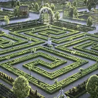 Labyrinthe de jardins complexes avec des haies entretenues, des allées, des statues et des arches ornées de fleurs et de verdure. DR