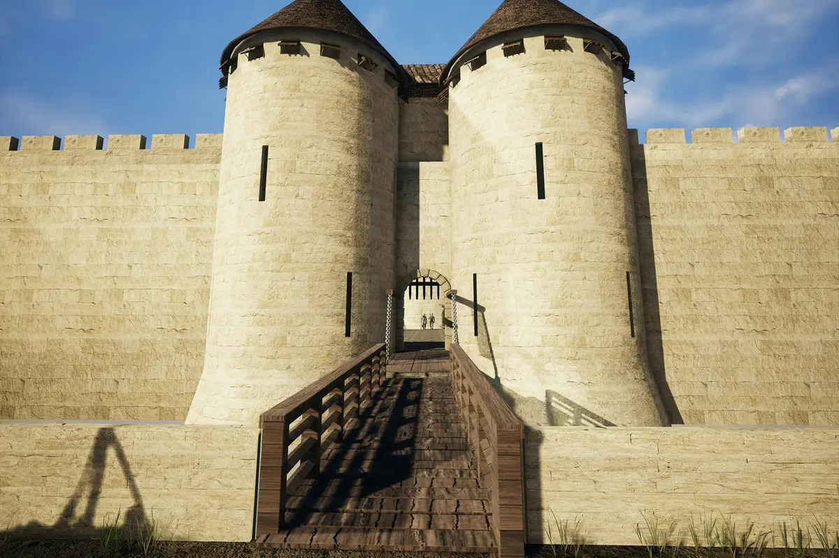 Un château médiéval en pierre avec deux tours cylindriques, un pont en bois menant à son entrée et un ciel bleu clair.