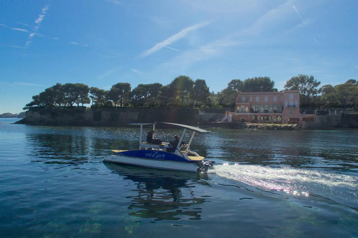 The boat is passing in front of a famous villa