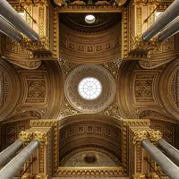 Plafond en dôme élaboré, orné d'or, vu d'en bas, avec de grandes colonnes et des sculptures détaillées. &copy; Photo by Christian Skiada