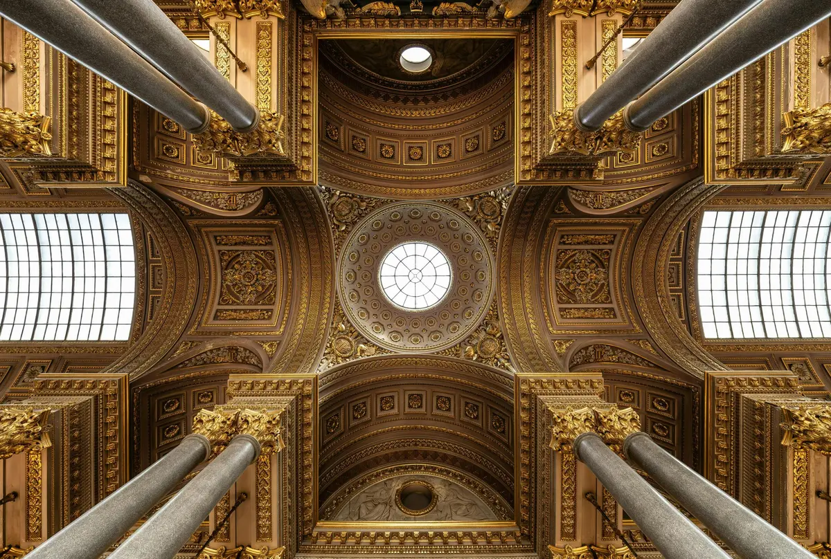 Elaborate, gold-ornamented dome ceiling viewed from below, with large columns and detailed carvings.