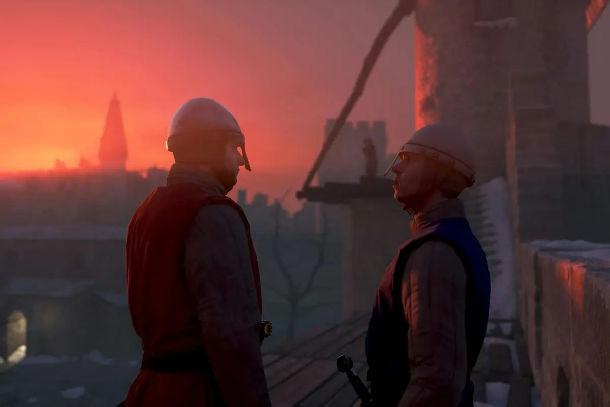 Deux hommes en armure se font face au coucher du soleil sur le toit d'un château, une tour lointaine et un autre personnage étant visibles à l'arrière-plan.