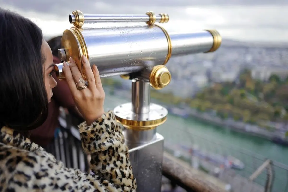 A woman looking through binoculars