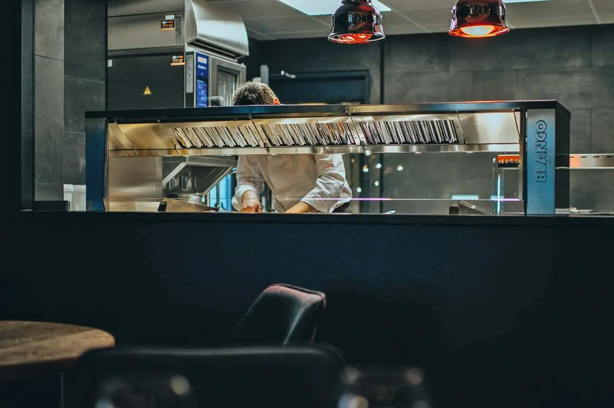 Depuis la (petite) salle, on aperçoit le chef en cuisine